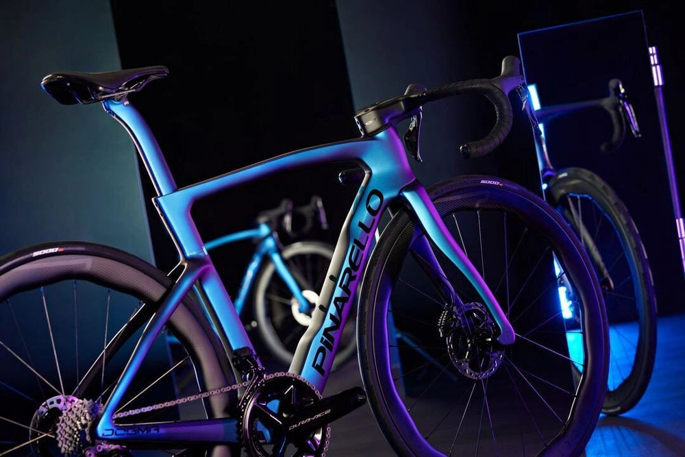 Sleek aerodynamic road bicycle with vibrant blue frame and black components.