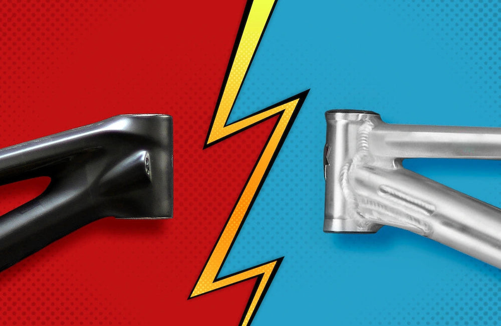 Comparison of carbon and aluminum bike frames on a split red and blue background.