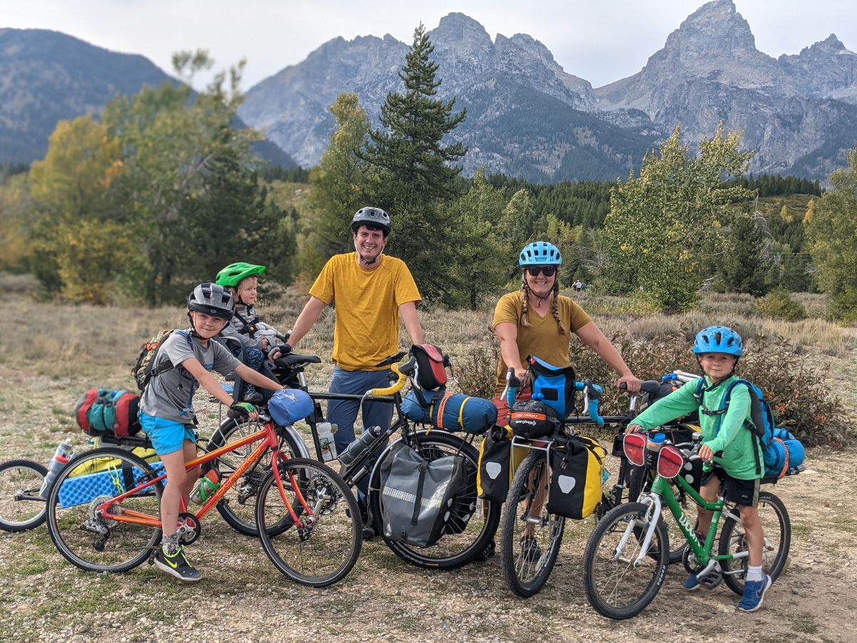 A family with four children on a cycling trip in a mountainous area.