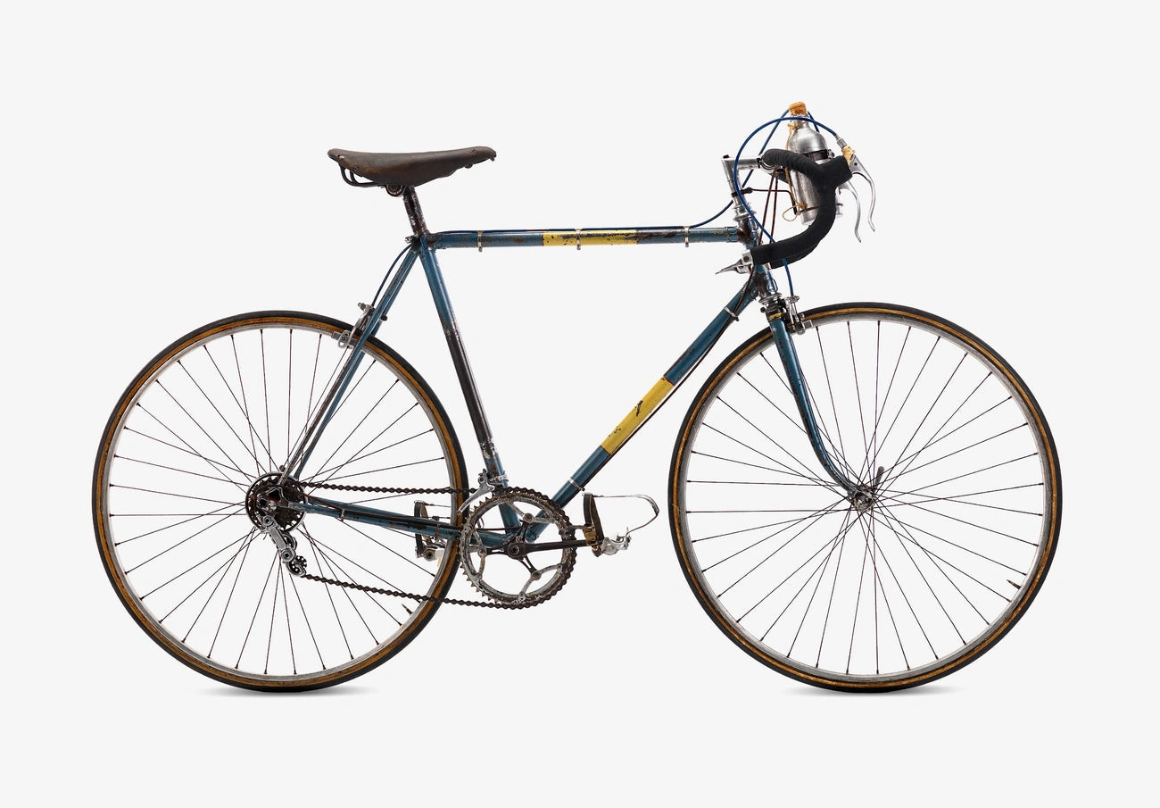 Vintage road bicycle with a blue and yellow frame against a white background.